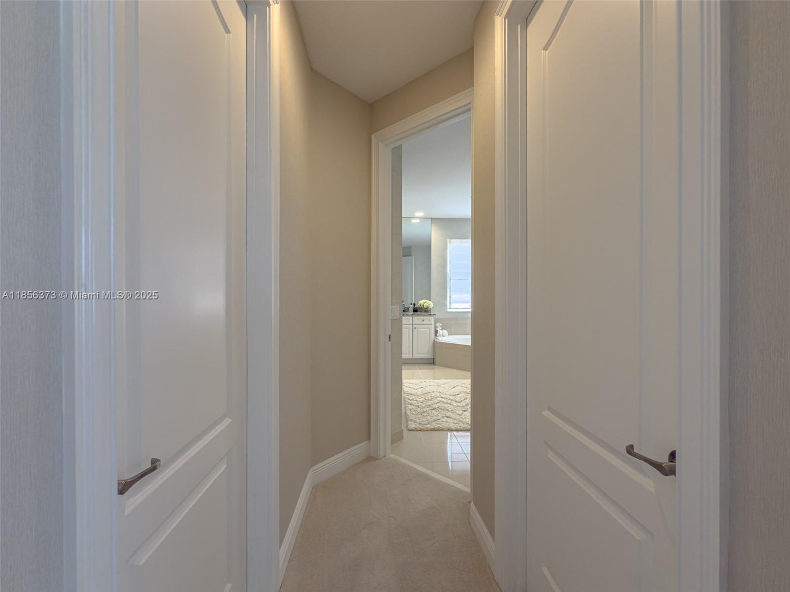 9709 Blue Isle Bay Parkland, FL 33076 - Photo 31 of 75 a view of a bathroom from a hallway