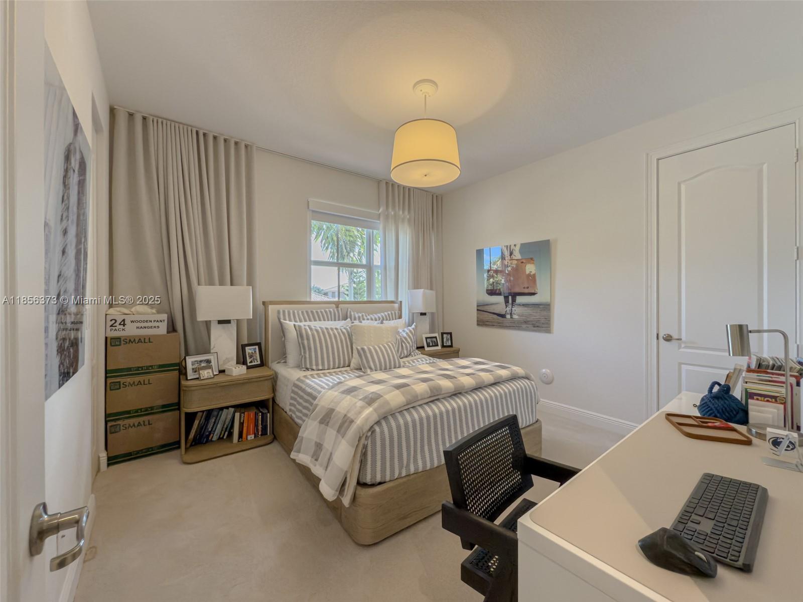 9709 Blue Isle Bay Parkland, FL 33076 - Photo 34 of 75 a bedroom with a bed and a chandelier