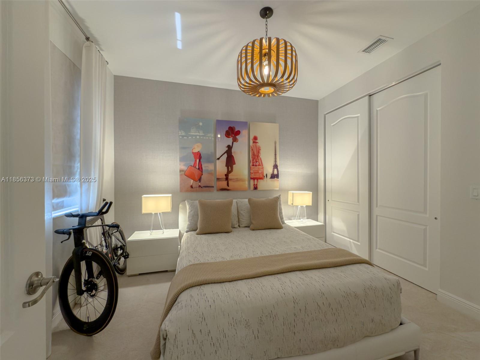 9709 Blue Isle Bay Parkland, FL 33076 - Photo 37 of 75 a bed room with a bed and a chandelier