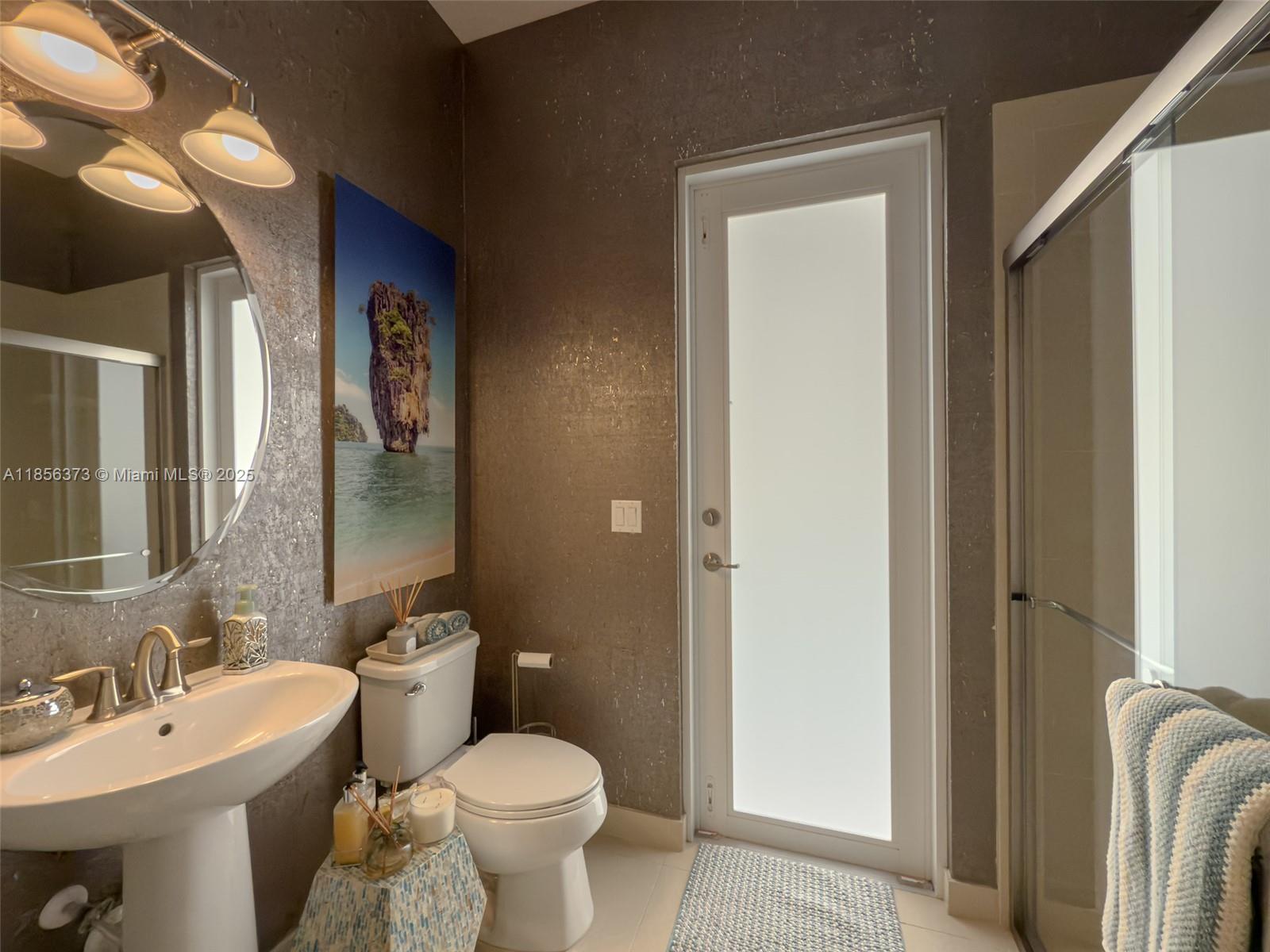 9709 Blue Isle Bay Parkland, FL 33076 - Photo 40 of 75 a bathroom with a sink and a toilet