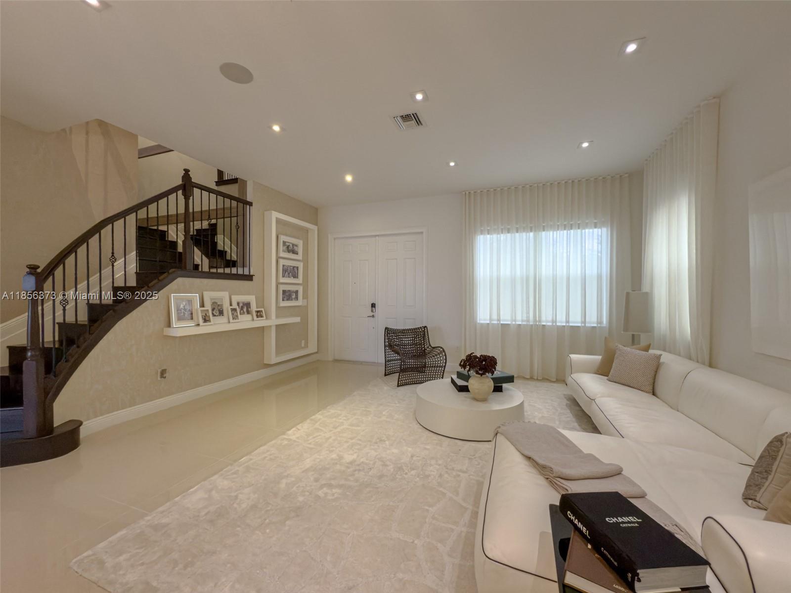 9709 Blue Isle Bay Parkland, FL 33076 - Photo 4 of 75 a view of a livingroom with furniture and windows