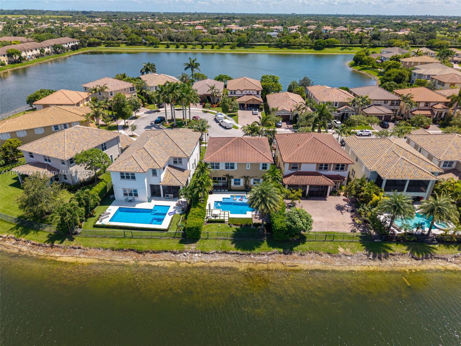 9709 Blue Isle Bay Parkland, FL 33076 - Photo 65 of 75 an aerial view of a house with a garden and lake view