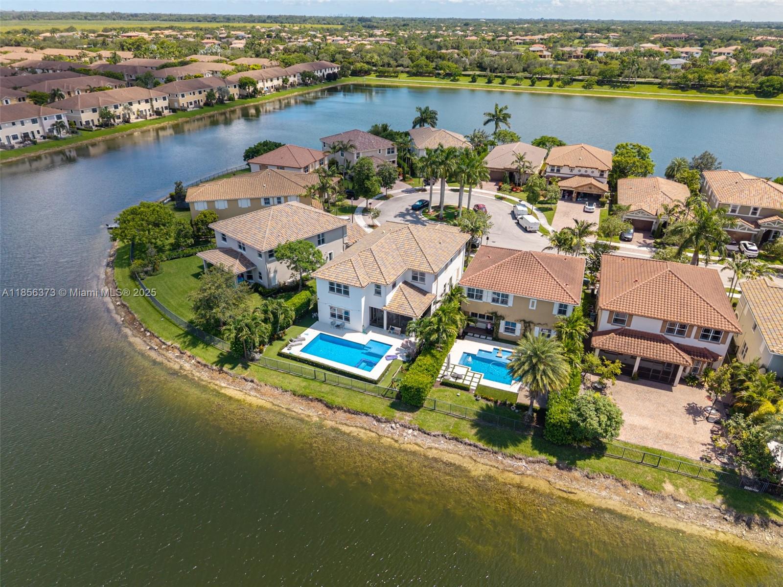 9709 Blue Isle Bay Parkland, FL 33076 - Photo 68 of 75 an aerial view of a house with outdoor space and lake view