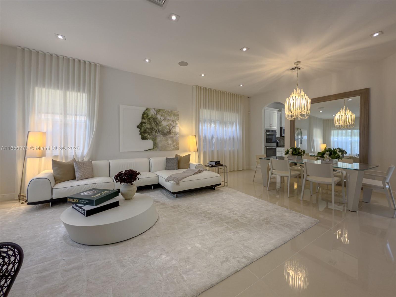 9709 Blue Isle Bay Parkland, FL 33076 - Photo 10 of 75 a living room with furniture and a chandelier