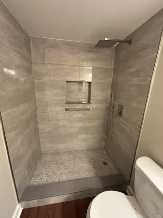 a bathroom with a shower and toilet