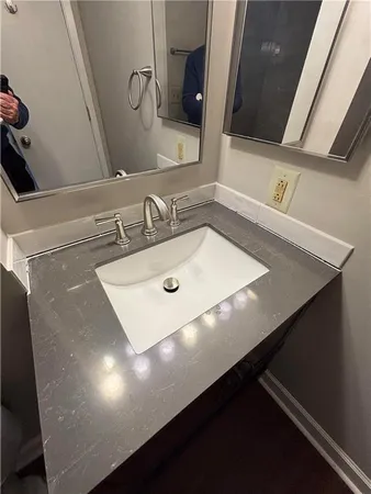 a bathroom with a sink vanity and a mirror