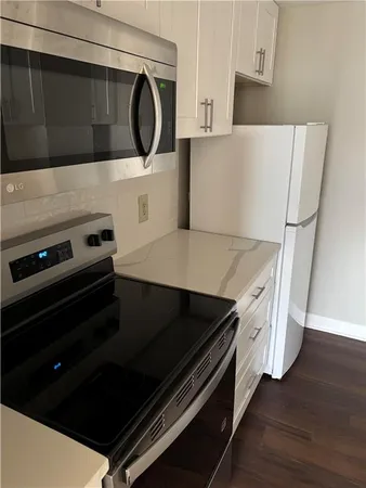 a kitchen with wooden cabinets and a stove top oven