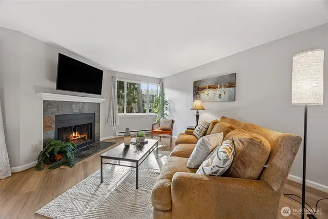 a living room with furniture a flat screen tv and a fireplace