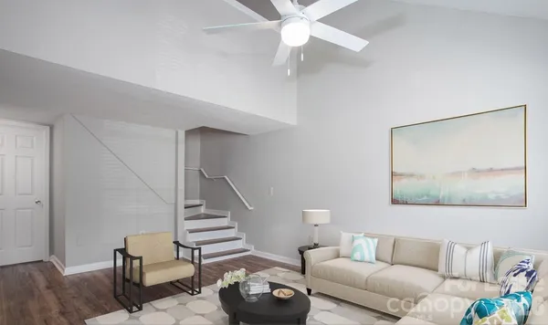 a living room with furniture and a painting