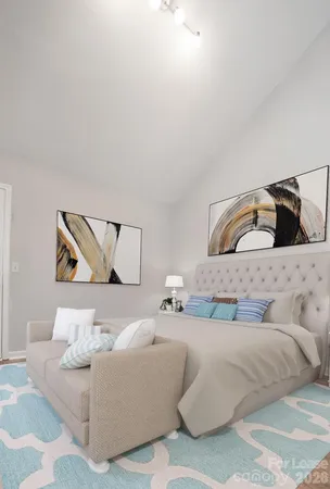 a bedroom with a bed and couch