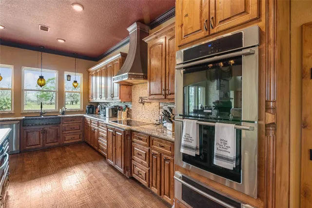 a kitchen with stainless steel appliances granite countertop a stove and a refrigerator