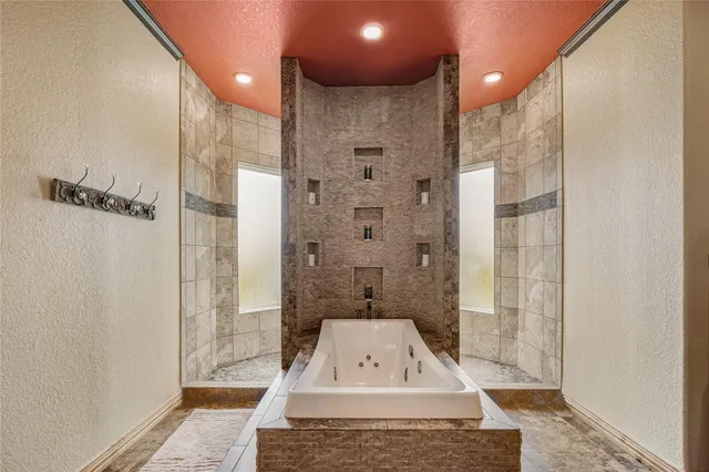 a bathroom with a granite countertop sink a shower and a mirror