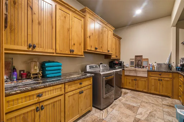 a kitchen with stainless steel appliances granite countertop a sink and cabinets