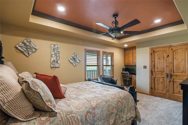 a bedroom with a large bed and a chandelier