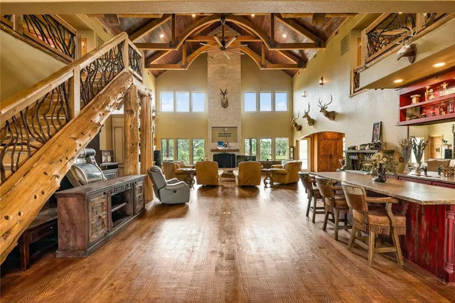 a living room with fireplace furniture and a wooden floor