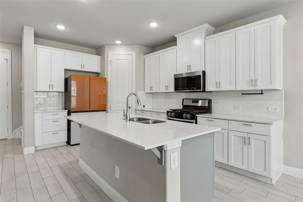525 Teton Street Allen, TX 75002 - Photo 1 of 31 a kitchen with a sink a stove a refrigerator and cabinets