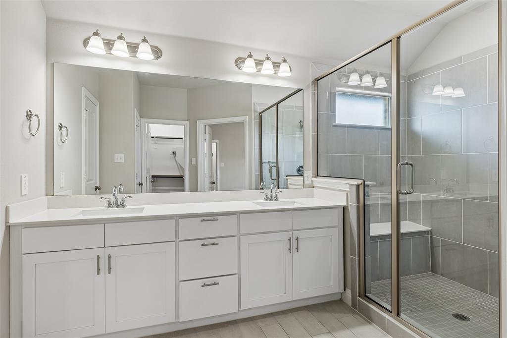 525 Teton Street Allen, TX 75002 - Photo 15 of 31 a bathroom with a double vanity sink and mirror