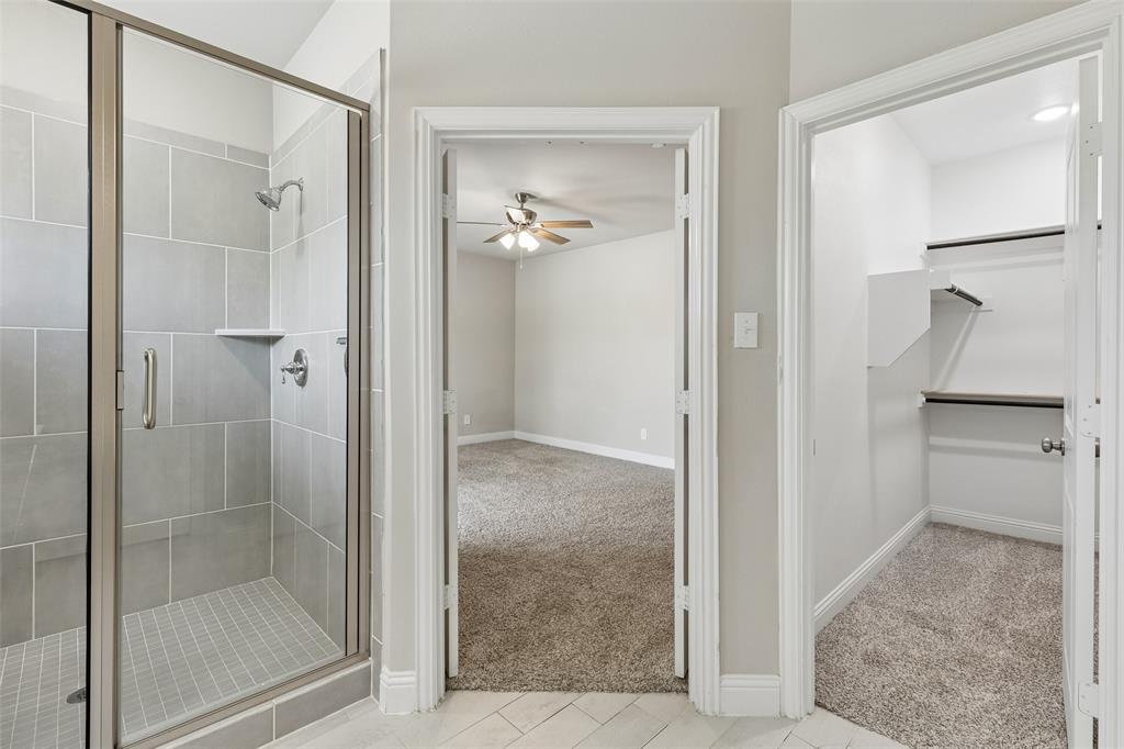 525 Teton Street Allen, TX 75002 - Photo 16 of 31 a bathroom with a glass shower door and a glass door