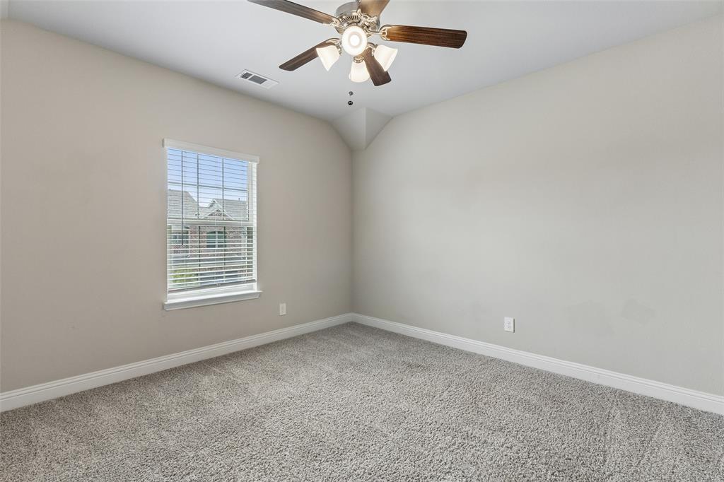 525 Teton Street Allen, TX 75002 - Photo 17 of 31 an empty room with a window and a fan