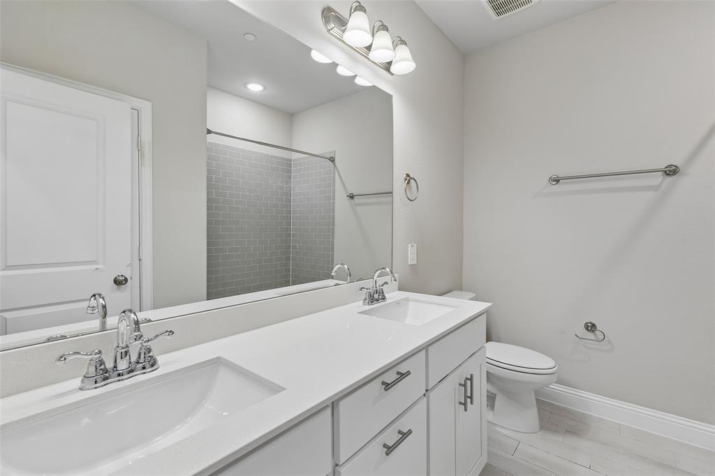 525 Teton Street Allen, TX 75002 - Photo 19 of 31 a bathroom with a double vanity sink mirror and toilet