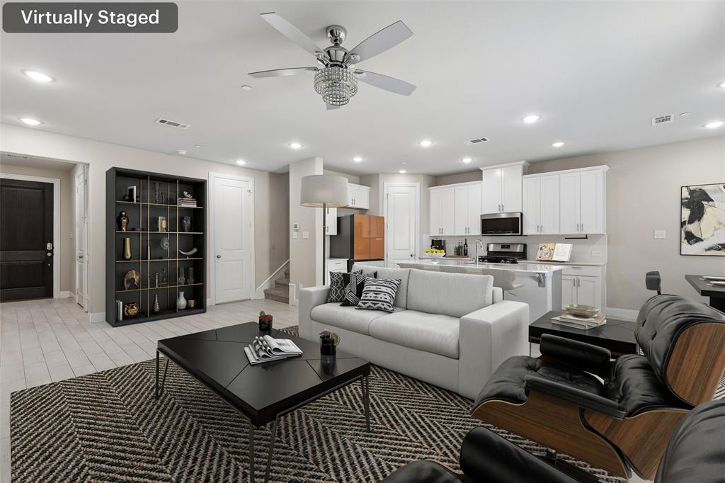 525 Teton Street Allen, TX 75002 - Photo 3 of 31 a living room with furniture a rug kitchen view and a chandelier