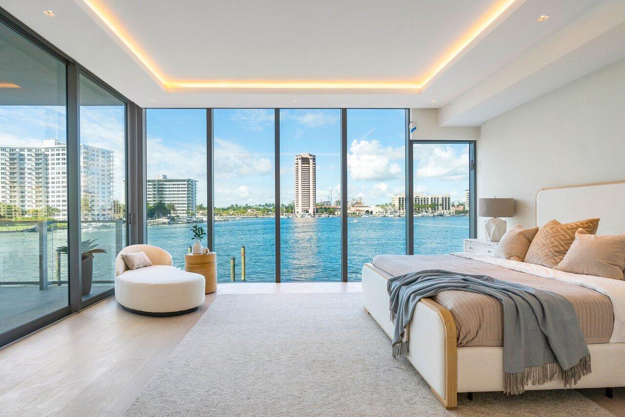 725 South Ocean Boulevard, Unit 202 Boca Raton, FL 33432 - Photo 11 of 57 a bedroom with a bed and glass top table