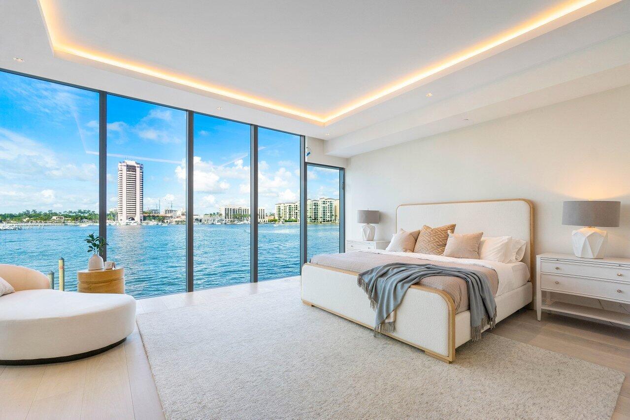 725 South Ocean Boulevard, Unit 202 Boca Raton, FL 33432 - Photo 12 of 57 a spacious bedroom with a large bed and a large window