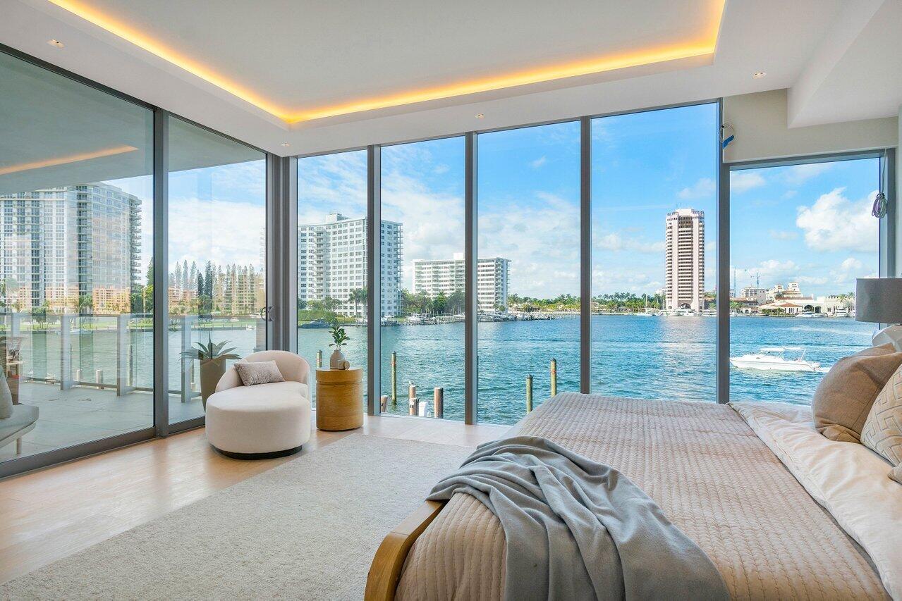 725 South Ocean Boulevard, Unit 202 Boca Raton, FL 33432 - Photo 13 of 57 a bed sitting in a bedroom next to a large window and a balcony