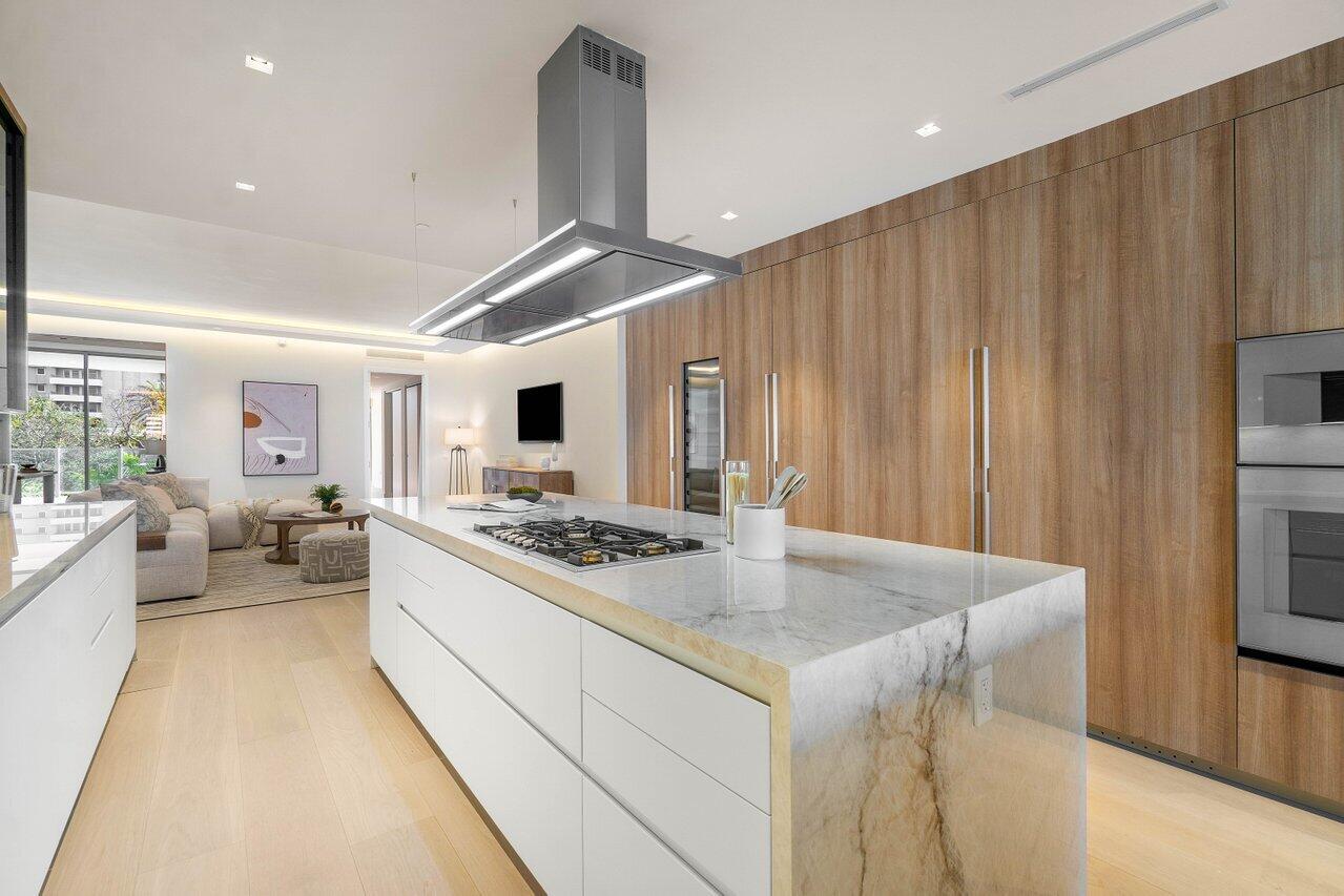 725 South Ocean Boulevard, Unit 202 Boca Raton, FL 33432 - Photo 29 of 57 a large white kitchen with a sink a stove and a refrigerator