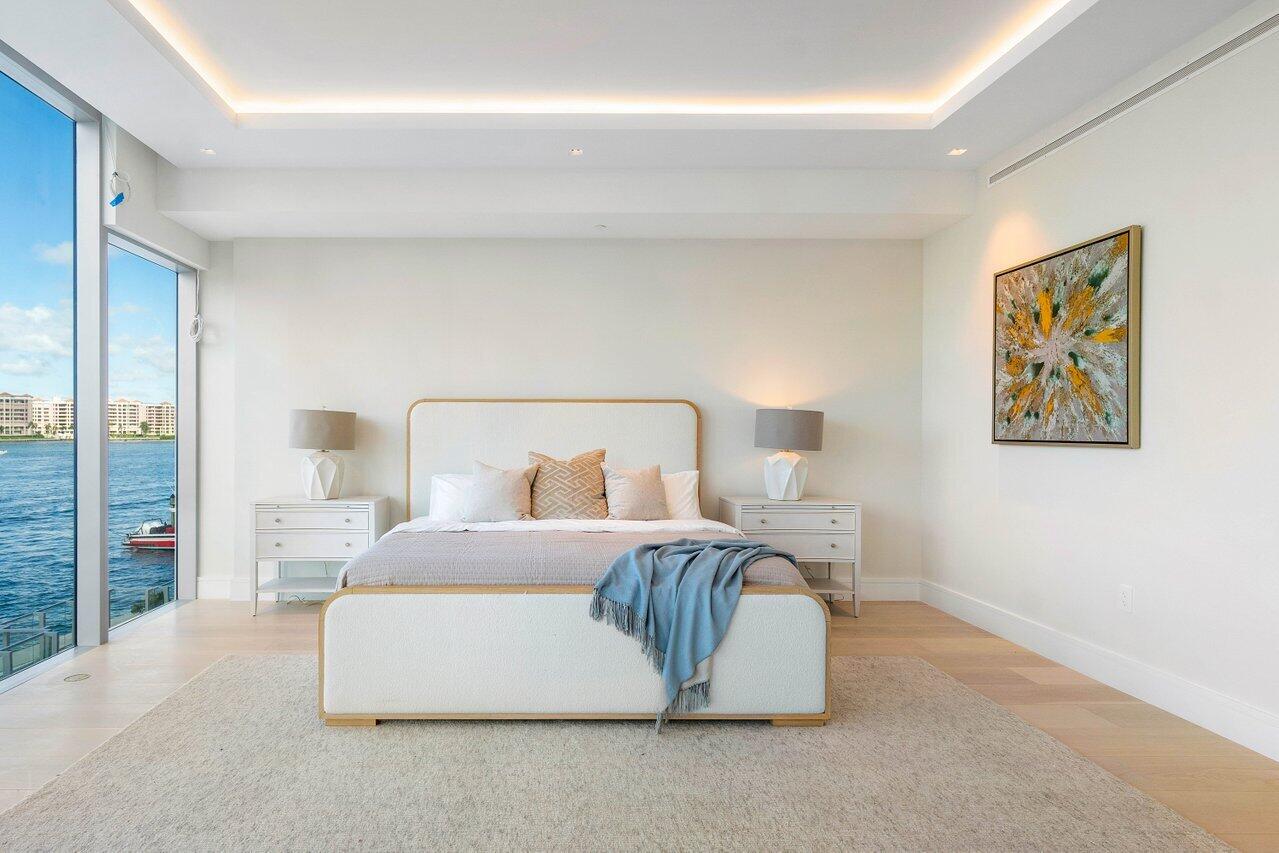 725 South Ocean Boulevard, Unit 202 Boca Raton, FL 33432 - Photo 33 of 57 a bedroom with a large bed and a painting on the wall