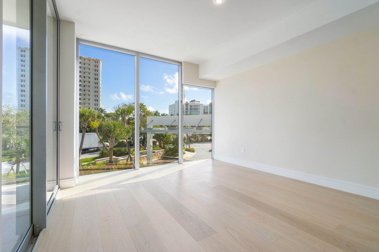 725 South Ocean Boulevard, Unit 202 Boca Raton, FL 33432 - Photo 36 of 57 a view of a room with wooden floor and windows
