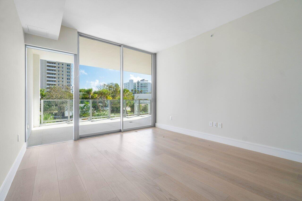 725 South Ocean Boulevard, Unit 202 Boca Raton, FL 33432 - Photo 39 of 57 a view of an empty room with wooden floor and a window