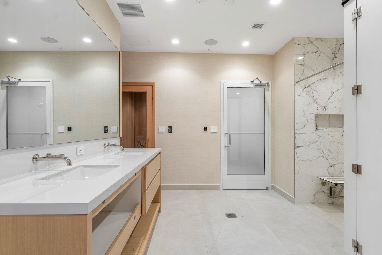 725 South Ocean Boulevard, Unit 202 Boca Raton, FL 33432 - Photo 52 of 57 a bathroom with a double vanity sink mirror and shower