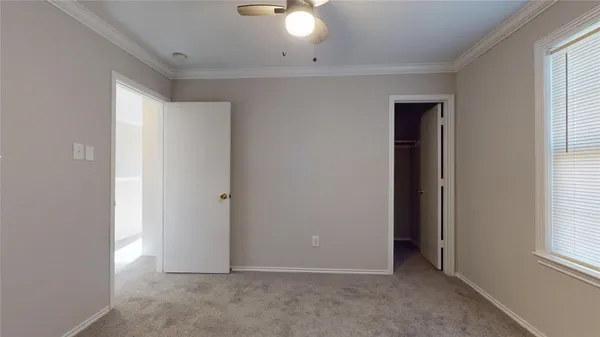 an empty room with windows and closet