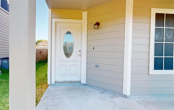 an entryway with wooden floor mirror and windows