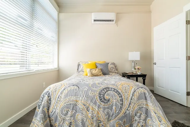 a bedroom with a bed and a window