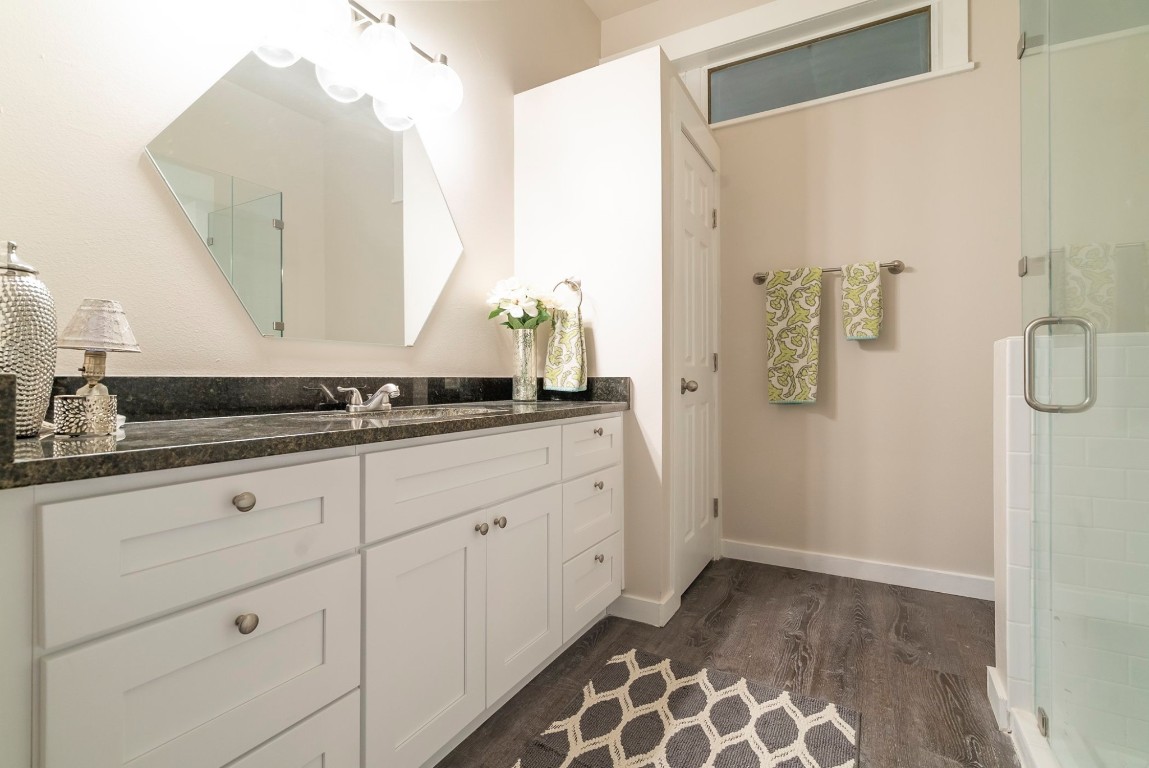 809 Vance Street Taylor, TX 76574 - Photo 9 of 10 a bathroom with a granite countertop sink and a mirror