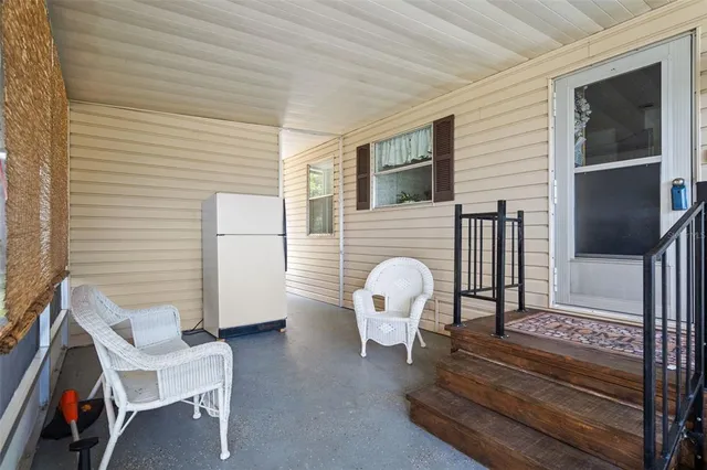 a view of two chairs in the balcony