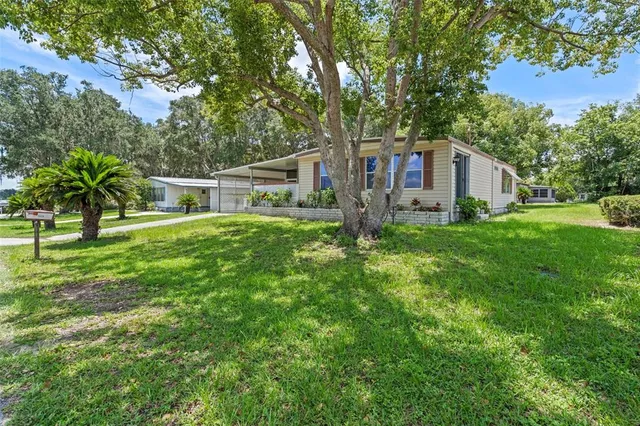 a view of a house with yard and a garden