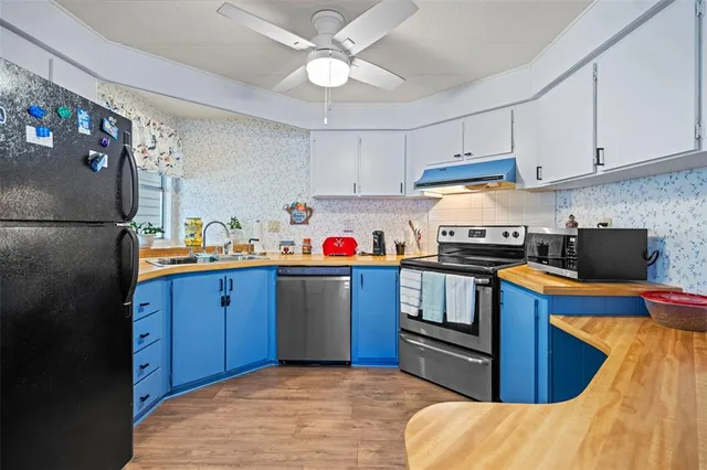 a kitchen with stainless steel appliances granite countertop a refrigerator a stove a sink dishwasher and a refrigerator