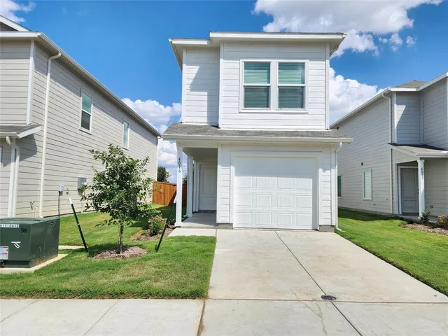 a front view of a house with a yard and porch