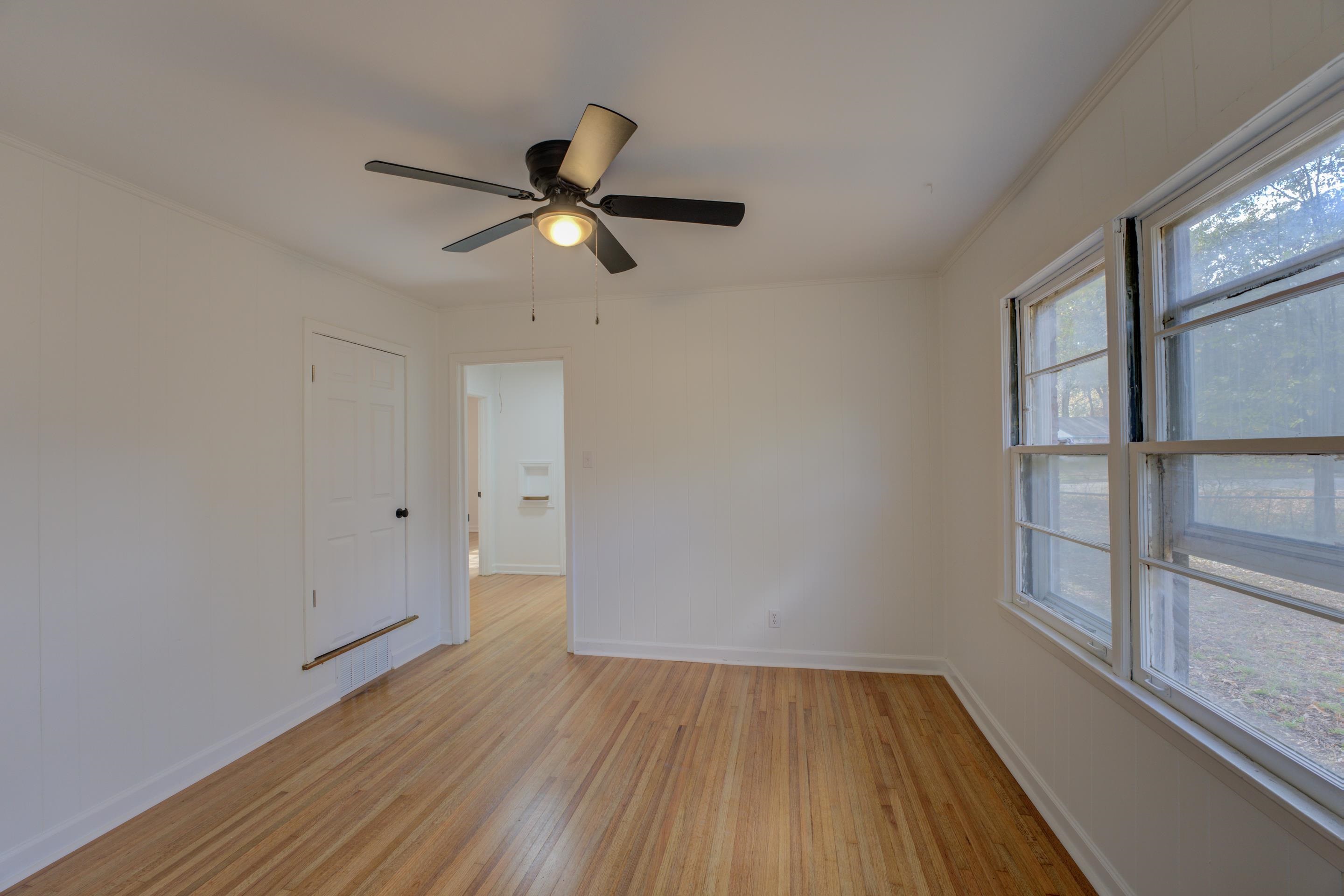 1609 South Perkins Road Memphis, TN 38117 - Photo 12 of 23 a view of empty room with wooden floor and fan
