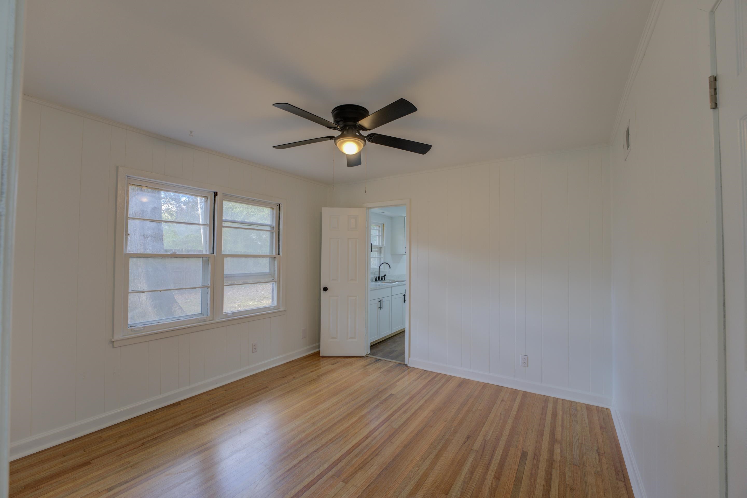 1609 South Perkins Road Memphis, TN 38117 - Photo 13 of 23 an empty room with wooden floor and windows