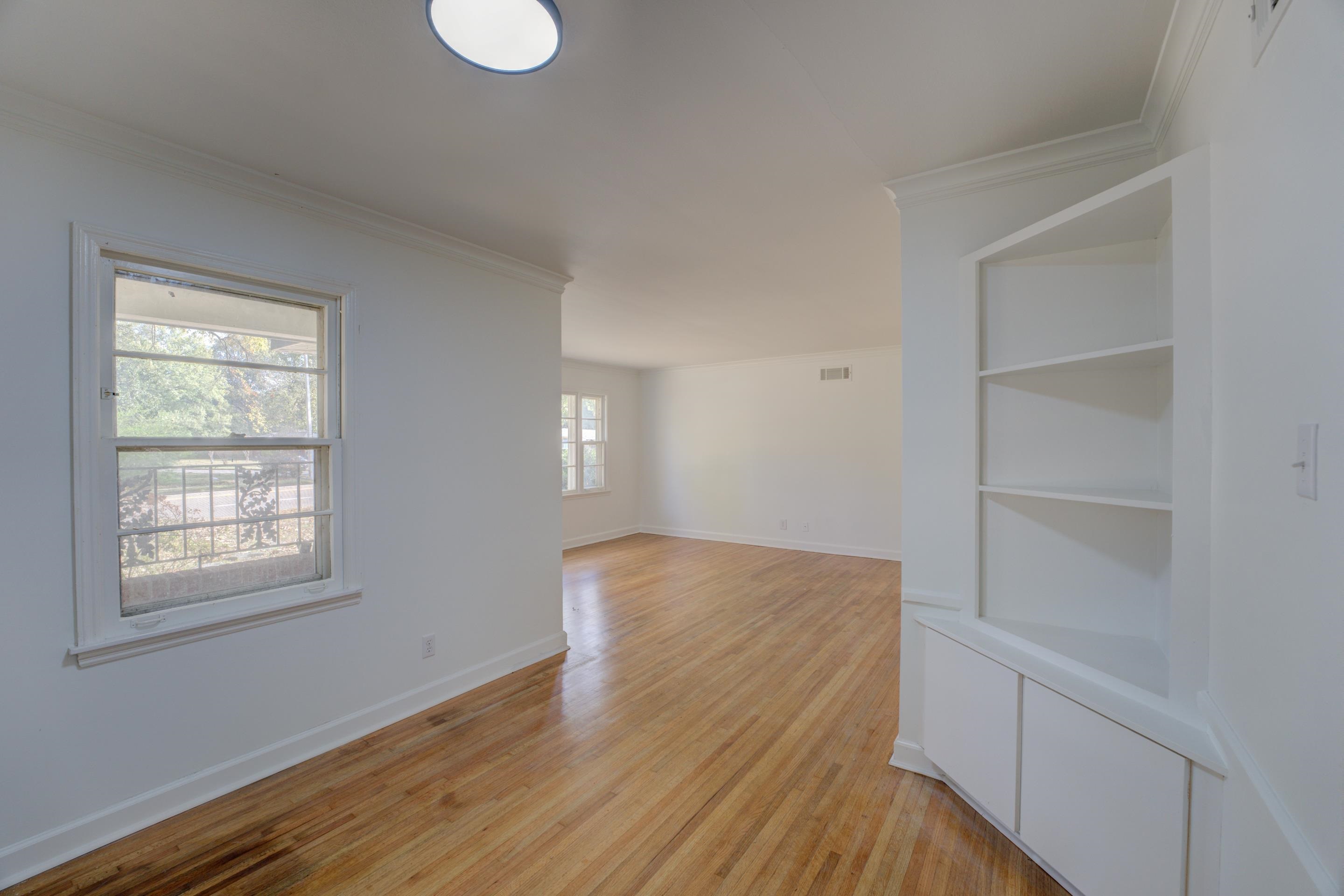 1609 South Perkins Road Memphis, TN 38117 - Photo 18 of 23 a view of empty room with wooden floor and fan