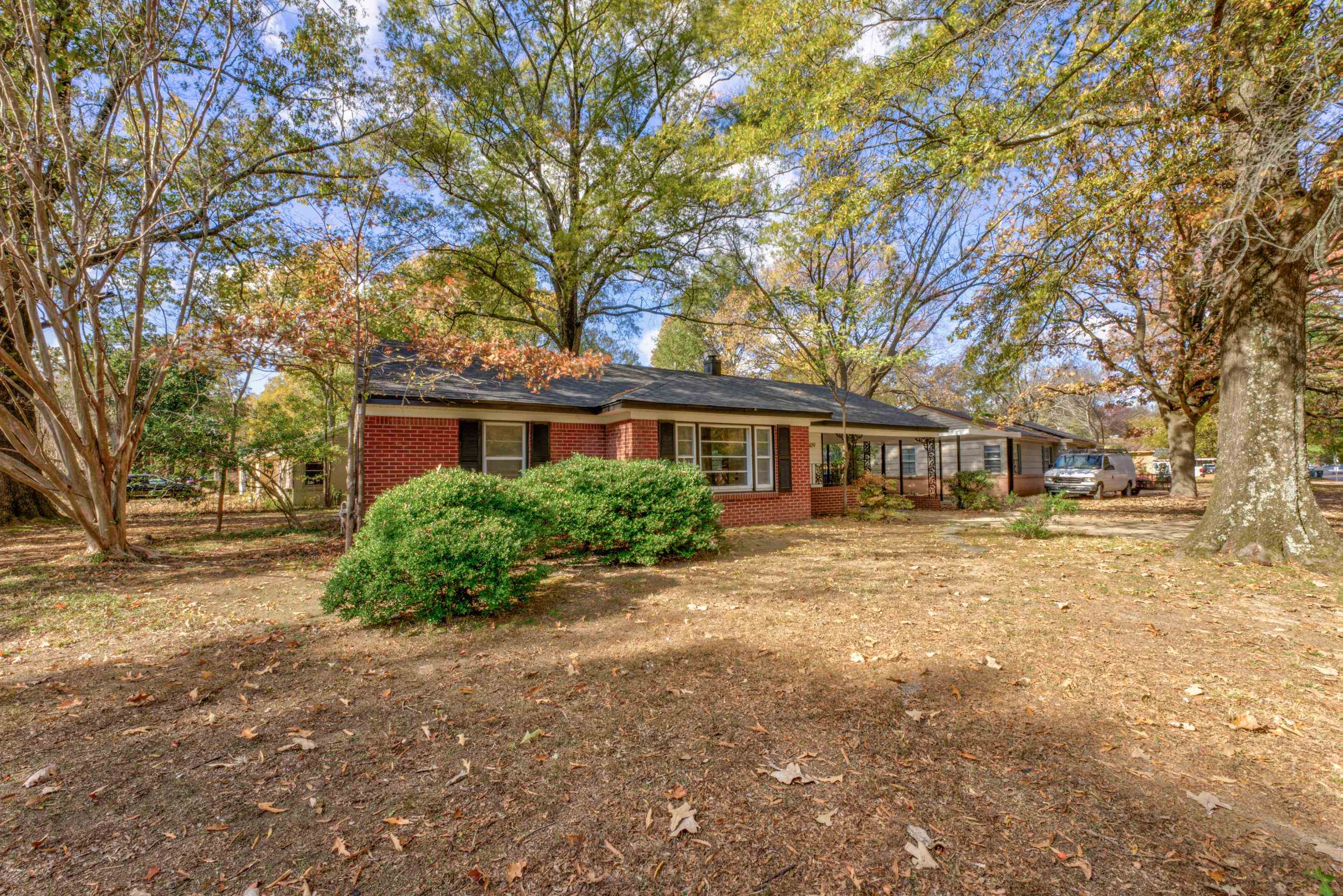 1609 South Perkins Road Memphis, TN 38117 - Photo 4 of 23 a front view of a house with a garden and trees