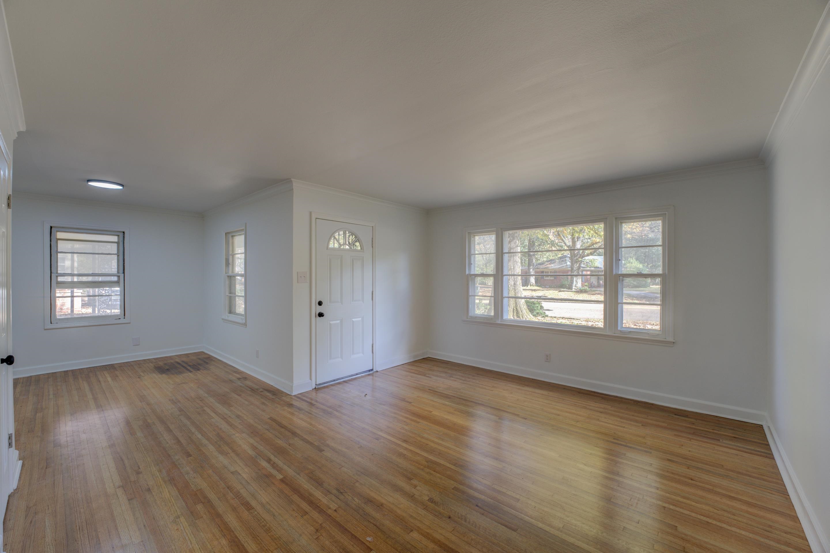 1609 South Perkins Road Memphis, TN 38117 - Photo 5 of 23 an empty room with wooden floor and windows