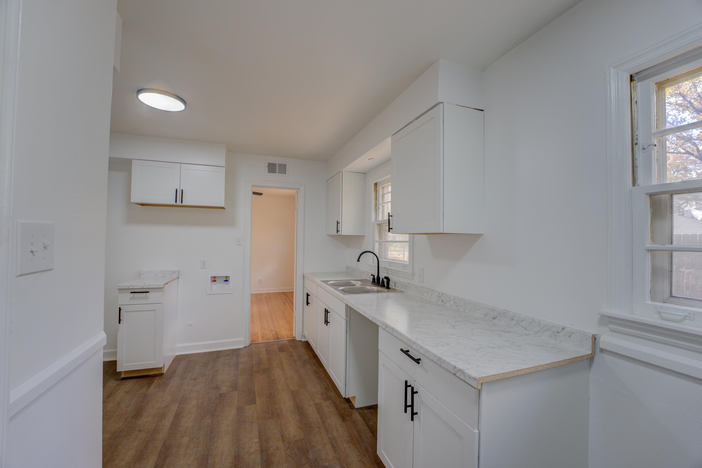 1609 South Perkins Road Memphis, TN 38117 - Photo 7 of 23 a kitchen with a sink a stove and cabinets