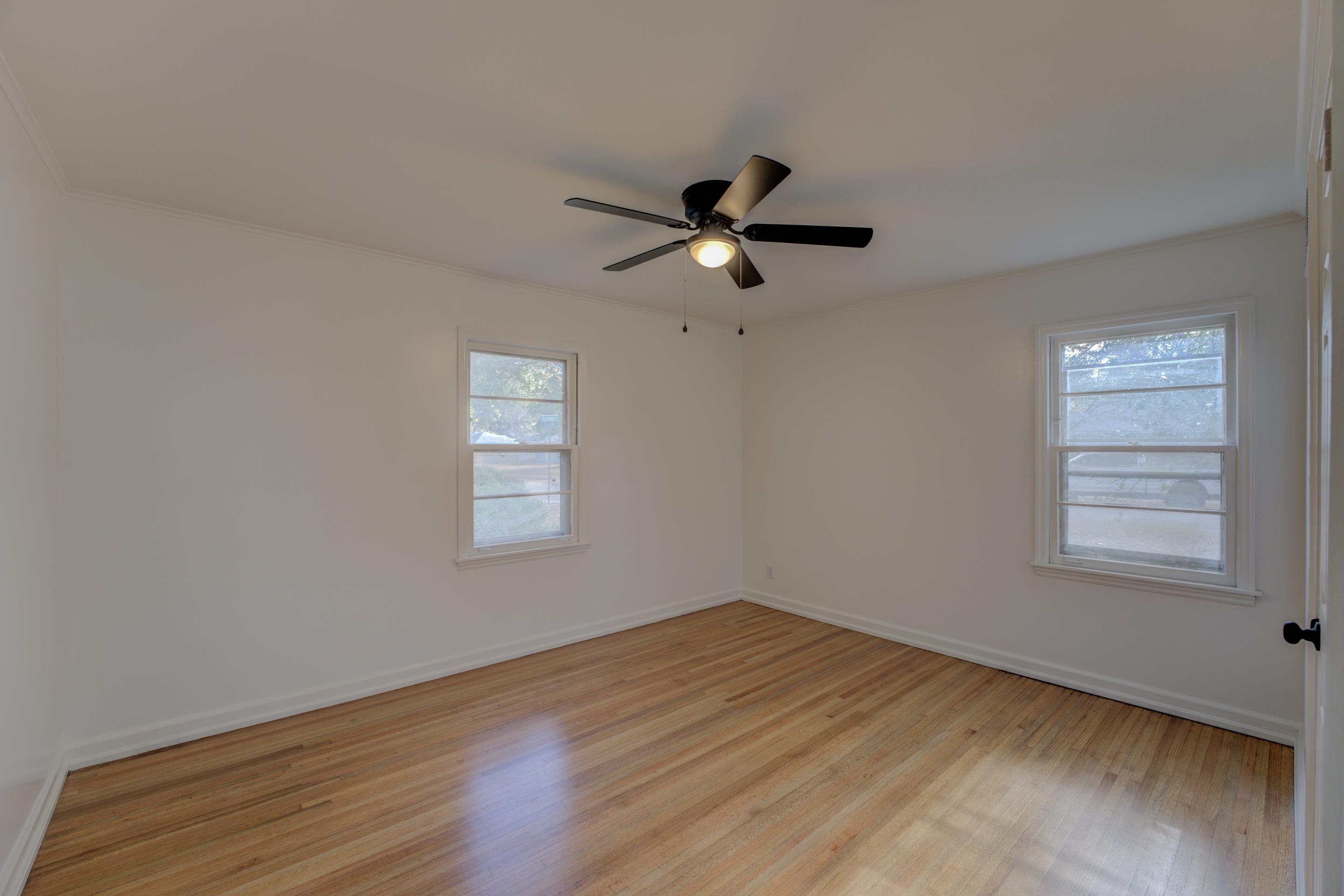 1609 South Perkins Road Memphis, TN 38117 - Photo 10 of 23 a view of empty room with wooden floor and fan