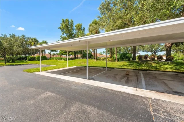 a view of a patio with a table and chairs under an umbrella