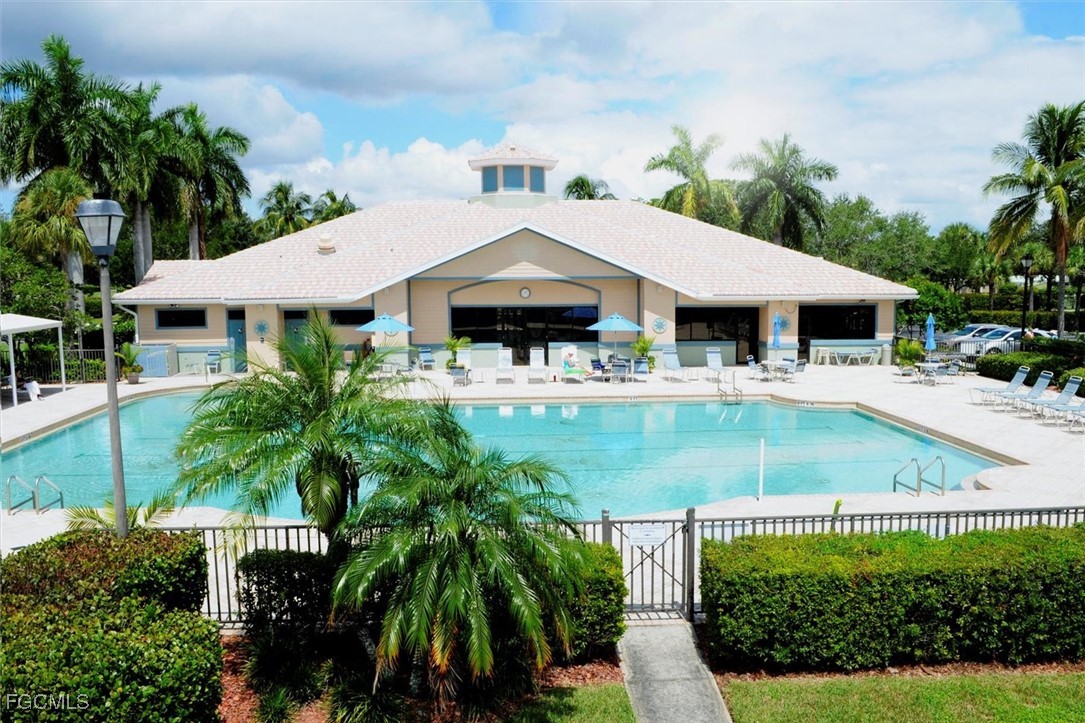 14111 Brant Point Circle, Unit 2106 Fort Myers, FL 33919 - Photo 23 of 31 a view of a white house with a yard potted plants and large tree